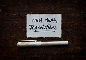 A sticky note with the word New year revolutions. Cherish U®