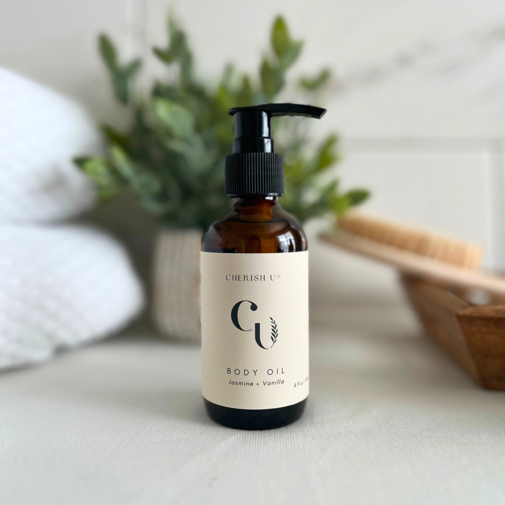 An amber bottle of Jasmine Vanilla body oil with a practical pump, stylishly displayed