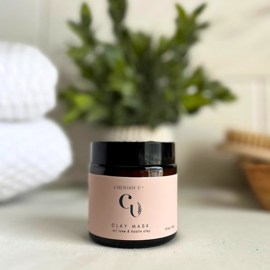 Amber jar of Rose Clay + Kaolin Clay Mask, designed to exfoliate and rejuvenate the skin with rose and kaolin clays Cherish U®