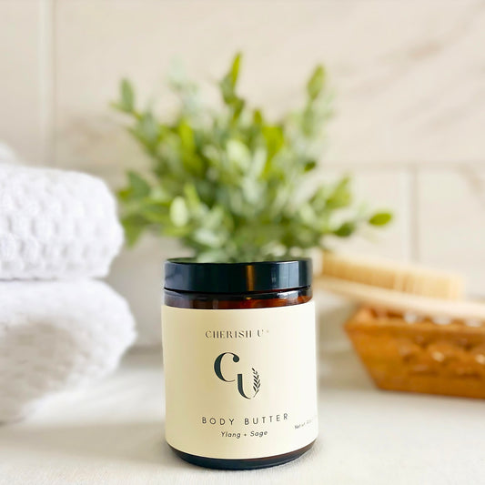 Amber jar of Ylang + Sage Body Butter, designed to deeply hydrate and nourish the skin with ylang-ylang and sage natural fragrance. Cherish U®