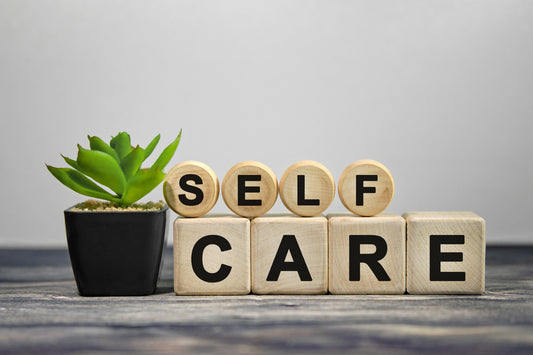 Wooden letters that spell out self care.