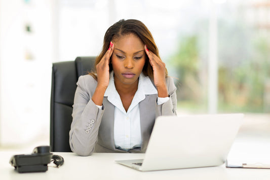 A woman stressed from doing to much work needed to find balance in her life.