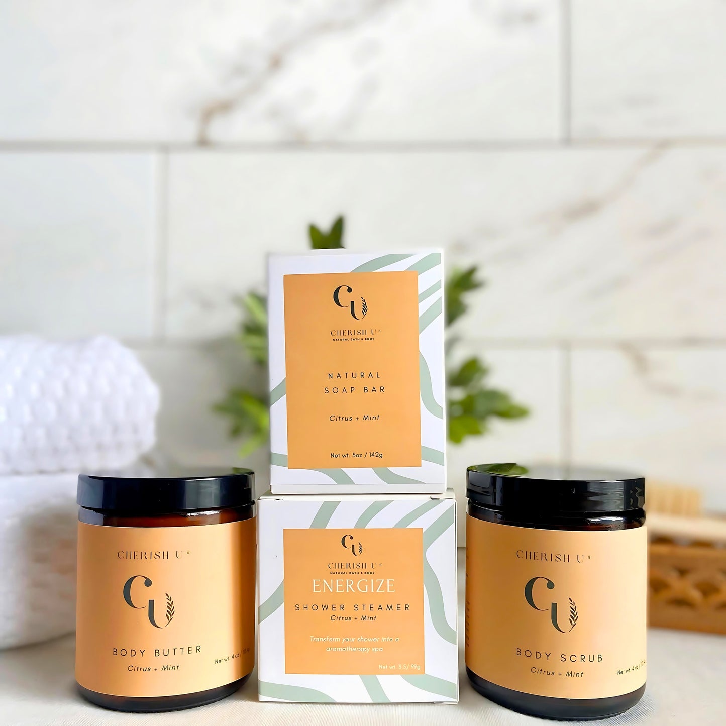 A spa shower gift set including Citrus + Mint soap, shower steamer, body butter, and sugar scrub for a refreshing and invigorating experience. Cherish U®