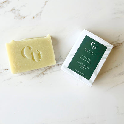 Handcrafted French green clay soap infused with tea tree and lavender essential oils, perfect for soothing and cleansing the skin naturally