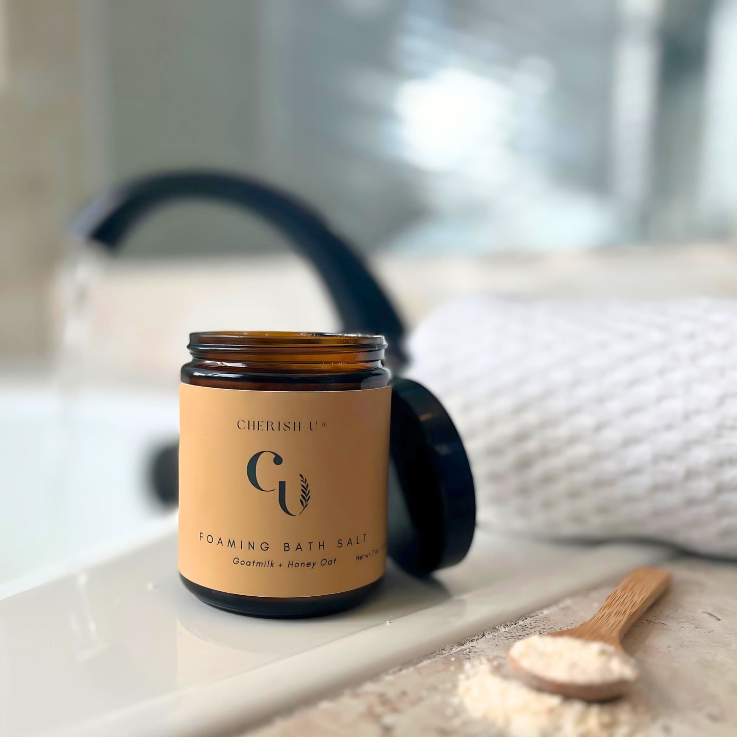 A jar of Goatmilk + Honey Oat foaming bath salts, crafted to nourish and soften the skin with a gentle, soothing blend of goatmilk, honey, and oats Cherish U®