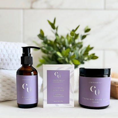 Amber jars and bottles of the Relax Spa Bath Set, featuring Lavender + Rosemary Citrus Soap, Lavender Foaming Bath Salt, and Lavender Body Oil, arranged to create a calming and relaxing bath time retreat.