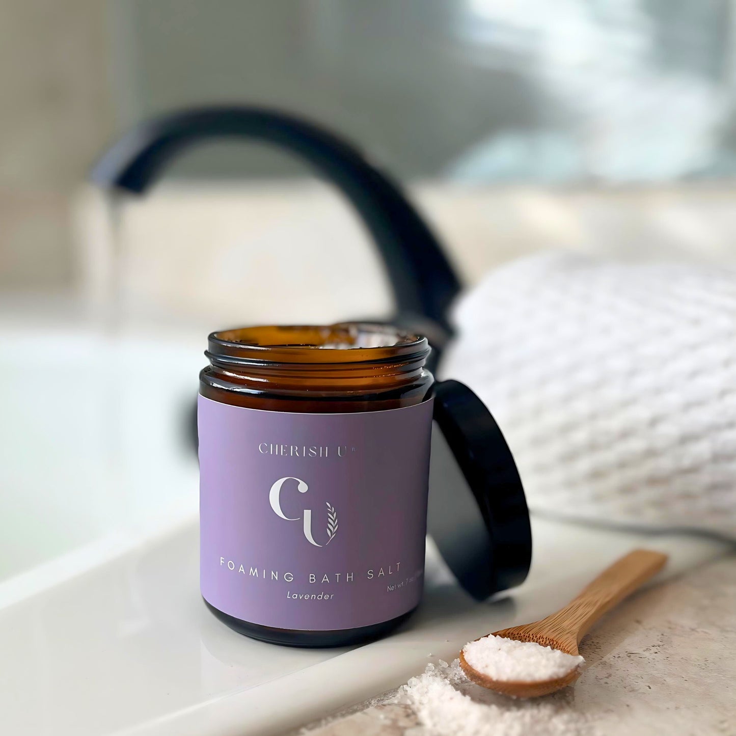 A jar of Lavender foaming bath salts, designed to create a calming and aromatic bath experience with the soothing scent of lavender Cherish U®