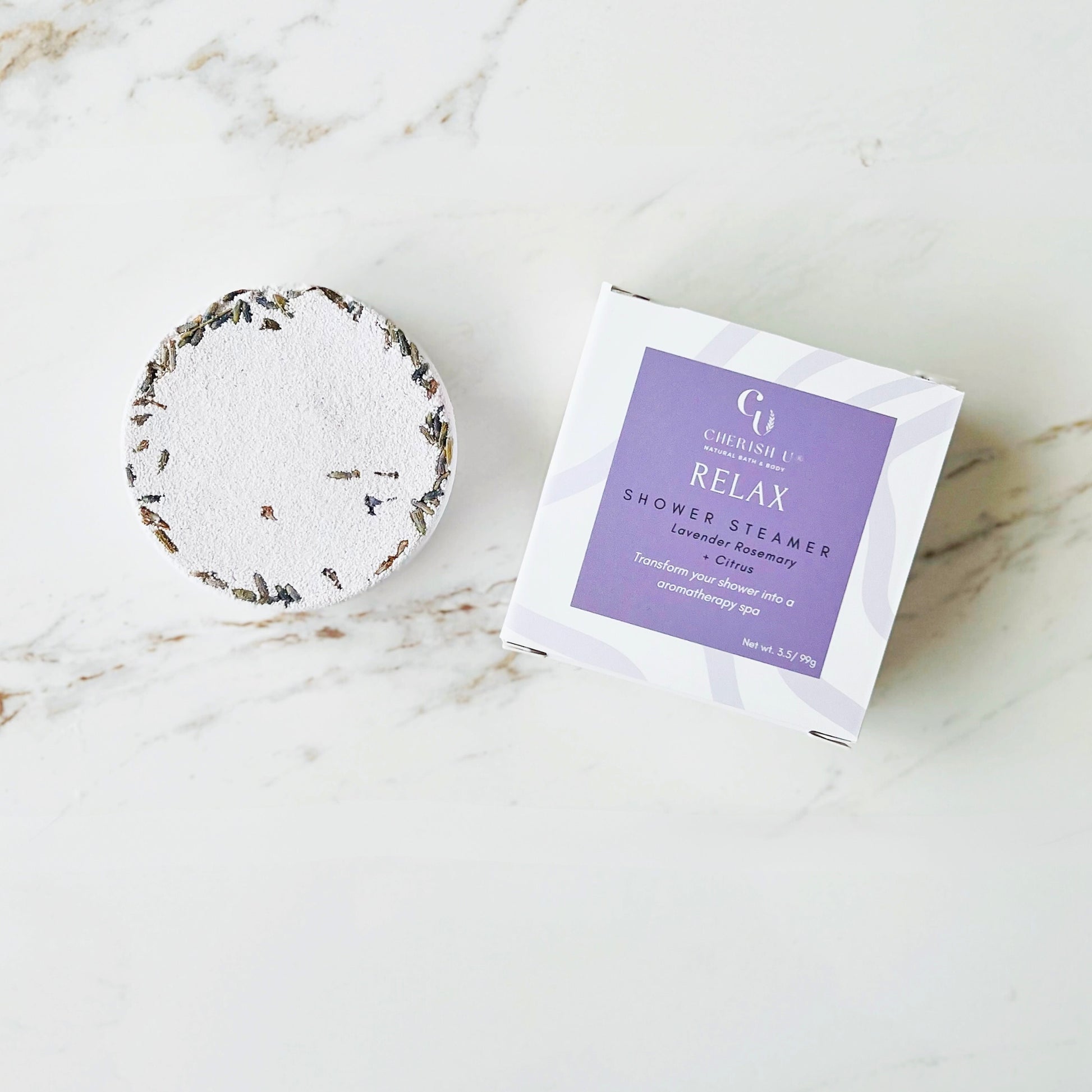 Lavender + Rosemary Citrus Shower Steamer, a natural tablet designed to release calming lavender, rosemary, and citrus aromas for a soothing shower experience.